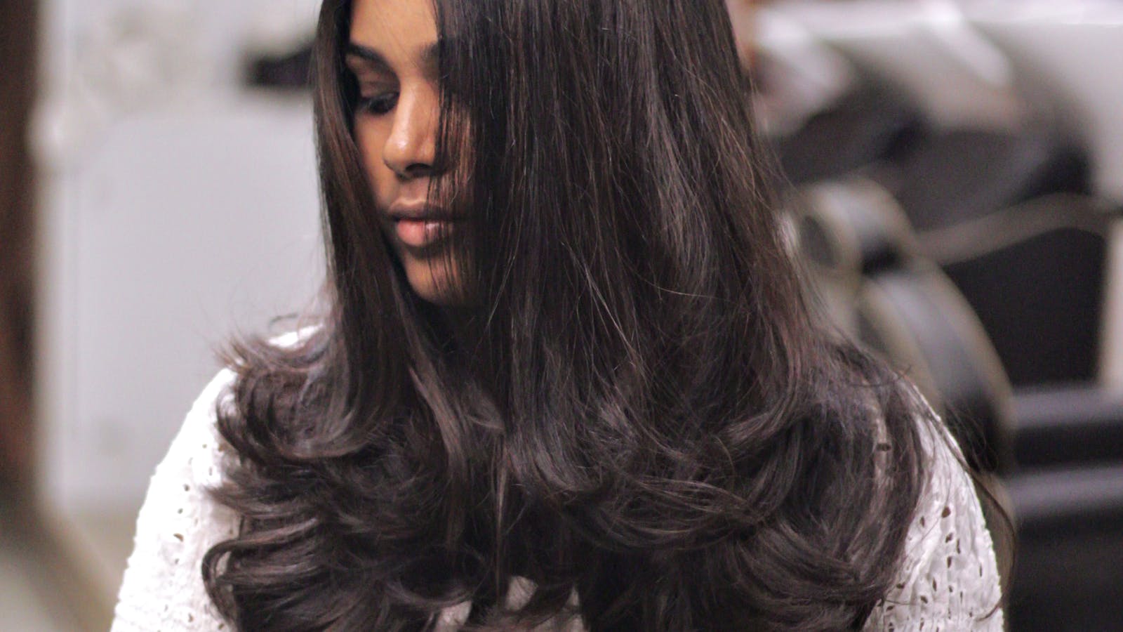 Silk-finish blowout result on long brunette hair