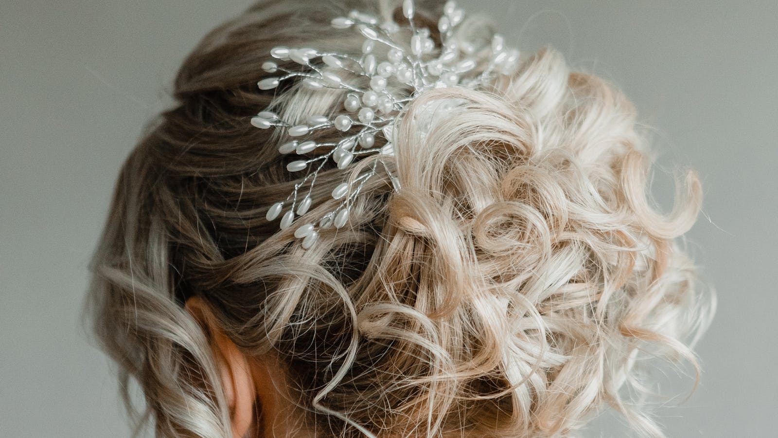 Elegant bridal updo with pearl hairpiece